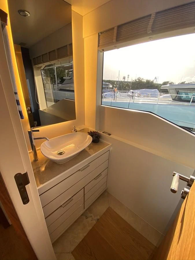 a bathroom with a sink and a window aboard PERSISTENCE Yacht for Sale