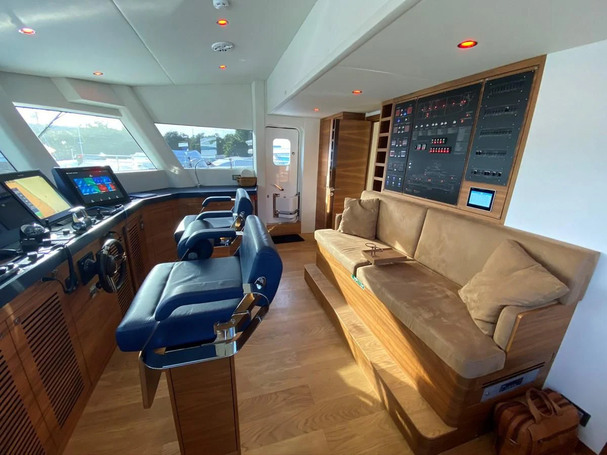 a living room with a couch and a table aboard PERSISTENCE Yacht for Sale