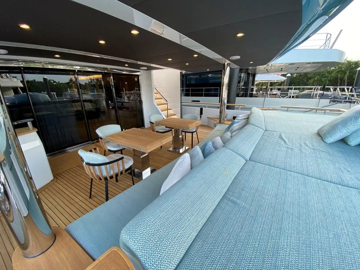a room with a bed and a table and chairs aboard PERSISTENCE Yacht for Sale