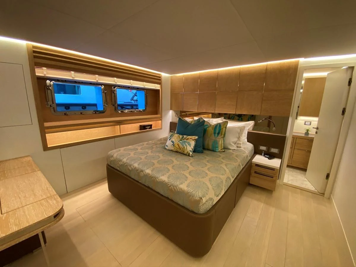 a room with a bed and a tv on the wall aboard PERSISTENCE Yacht for Sale