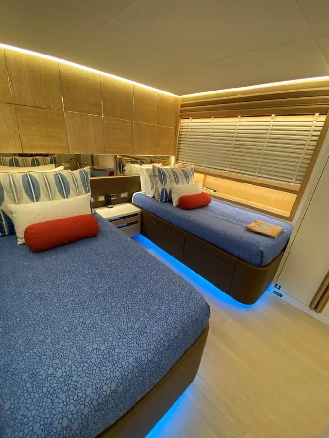 a bedroom with a blue bed aboard PERSISTENCE Yacht for Sale