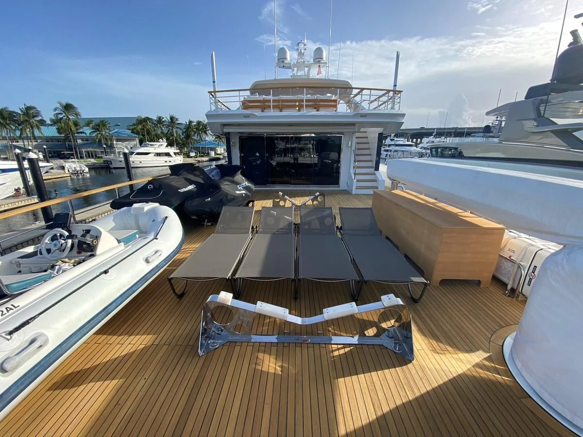 a deck with a deck and a boat on it aboard PERSISTENCE Yacht for Sale