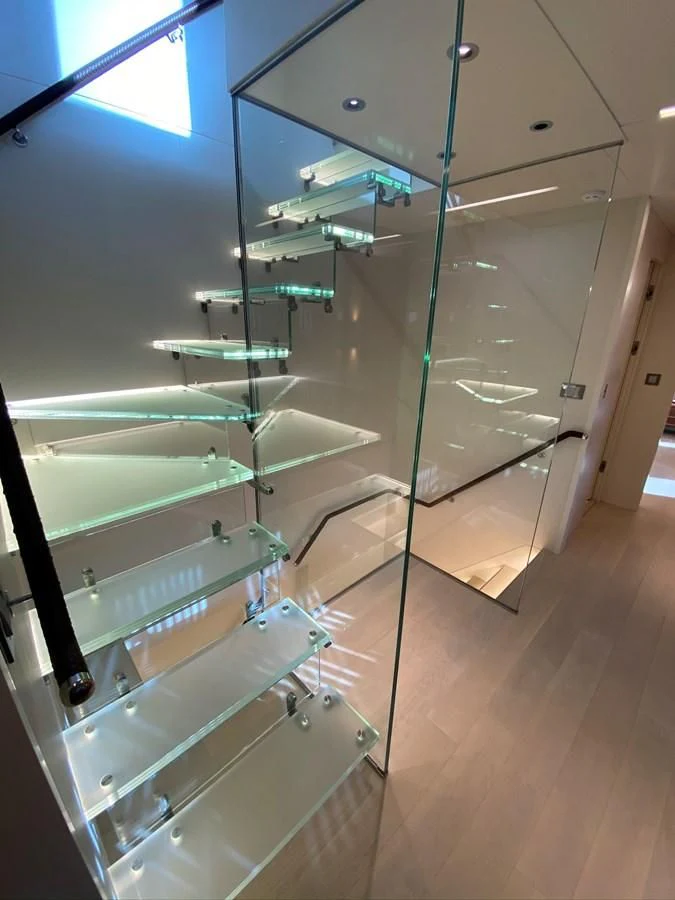 a glass wall with shelves aboard PERSISTENCE Yacht for Sale