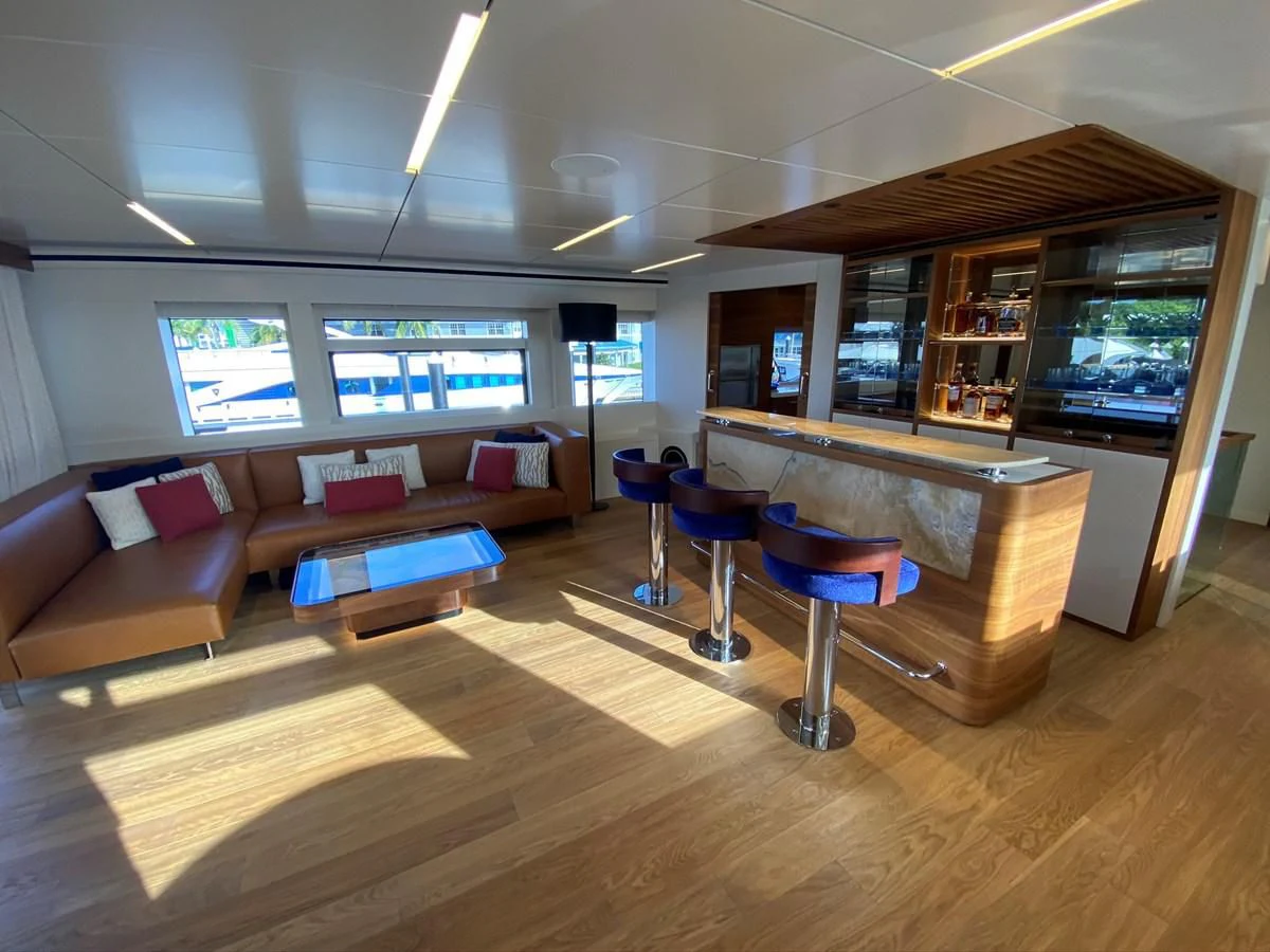 a living room with a large table and chairs aboard PERSISTENCE Yacht for Sale