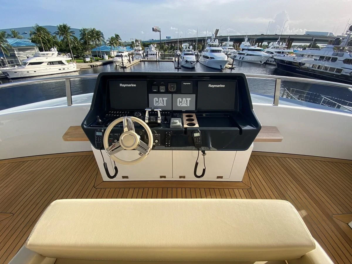 a black and white radio on a table with boats in the background aboard PERSISTENCE Yacht for Sale