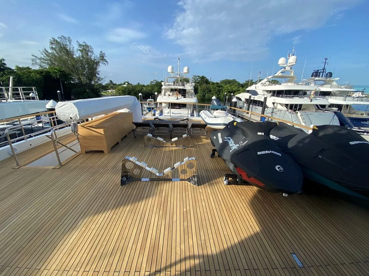 a deck with boats and a chair aboard PERSISTENCE Yacht for Sale