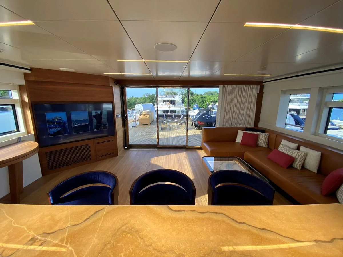 a living room with a large window aboard PERSISTENCE Yacht for Sale
