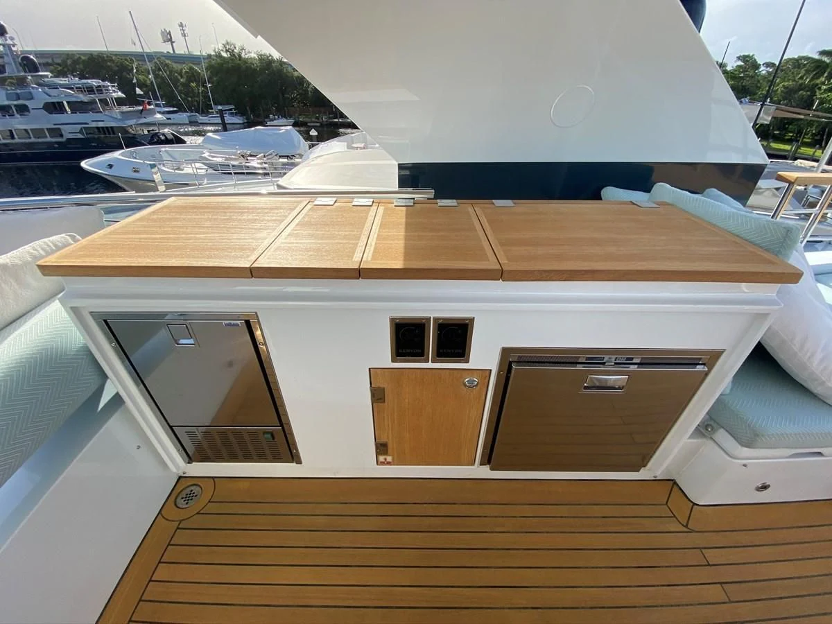 a wooden deck with a large boat in the background aboard PERSISTENCE Yacht for Sale