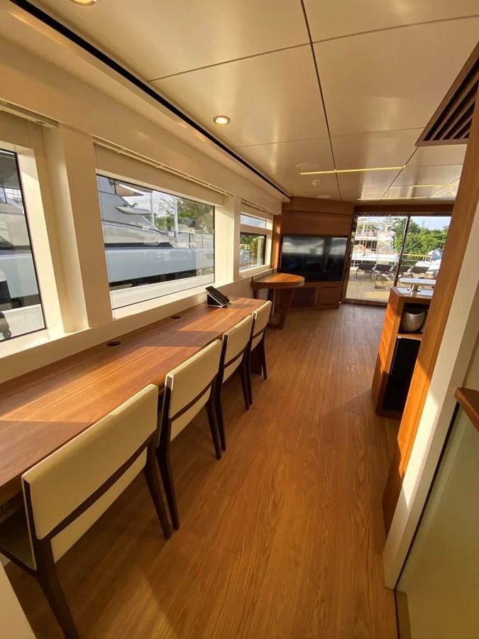 a room with tables and chairs aboard PERSISTENCE Yacht for Sale