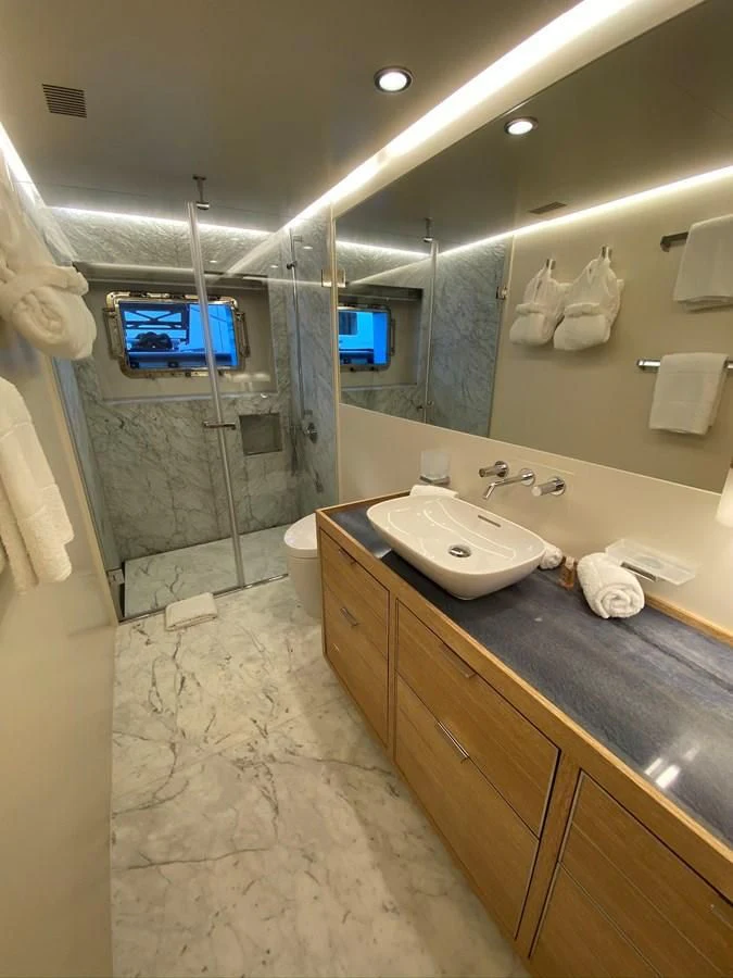 a bathroom with a countertop sink and a mirror aboard PERSISTENCE Yacht for Sale