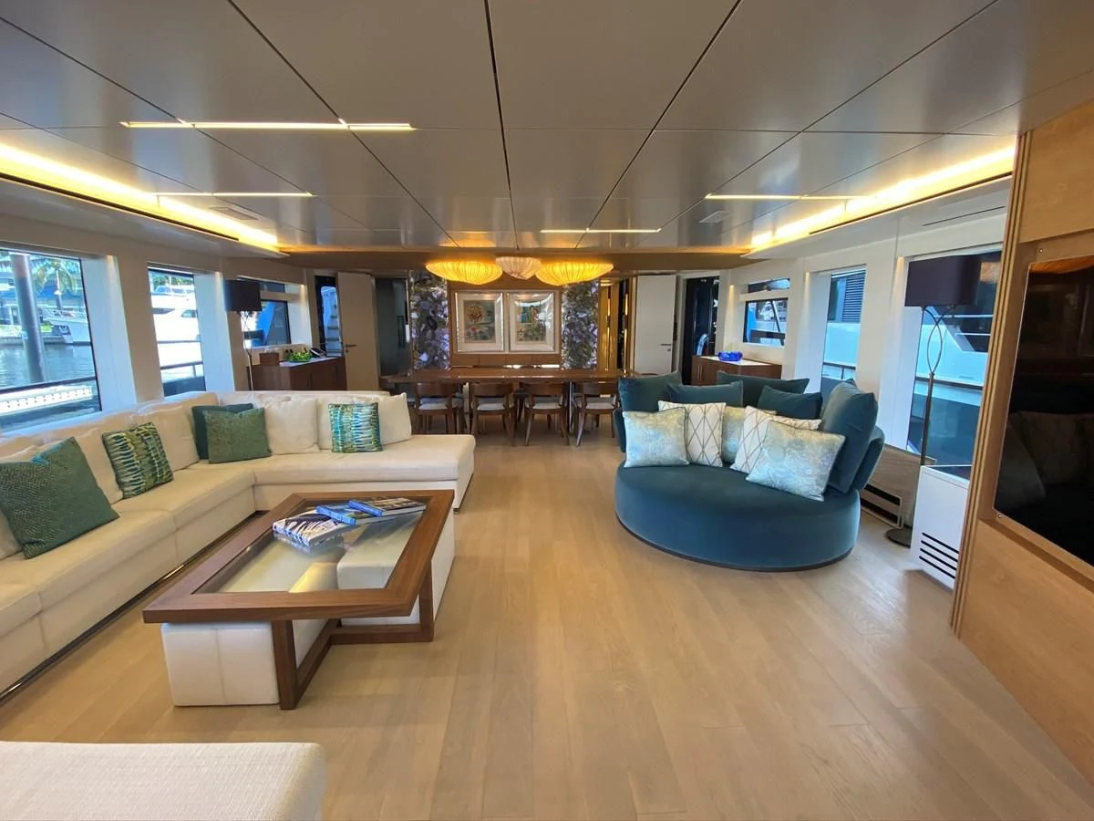 a living room with a couch and a coffee table aboard PERSISTENCE Yacht for Sale
