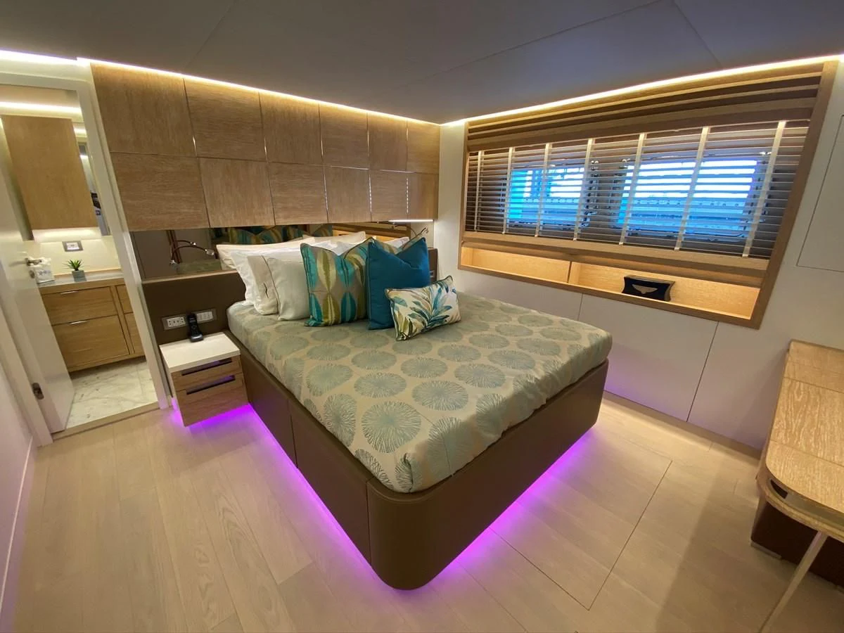 a bedroom with a bed and a window aboard PERSISTENCE Yacht for Sale