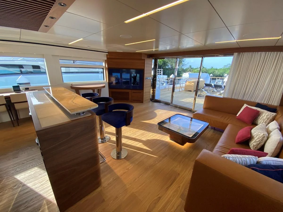 a room with a piano and a couch aboard PERSISTENCE Yacht for Sale
