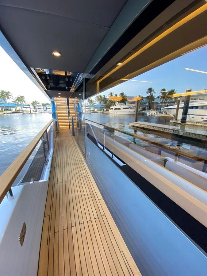 a wooden deck with a railing and a railing and a body of water aboard PERSISTENCE Yacht for Sale