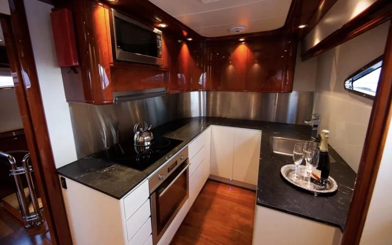 a kitchen with a black countertop aboard TIFFANY Yacht for Sale