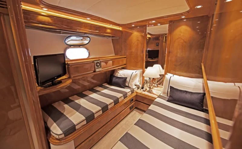 a room with a bed and a television aboard TIFFANY Yacht for Sale