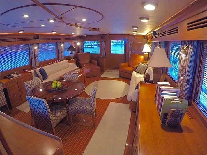 a room with a table chairs and a couch aboard BELLA Yacht for Sale