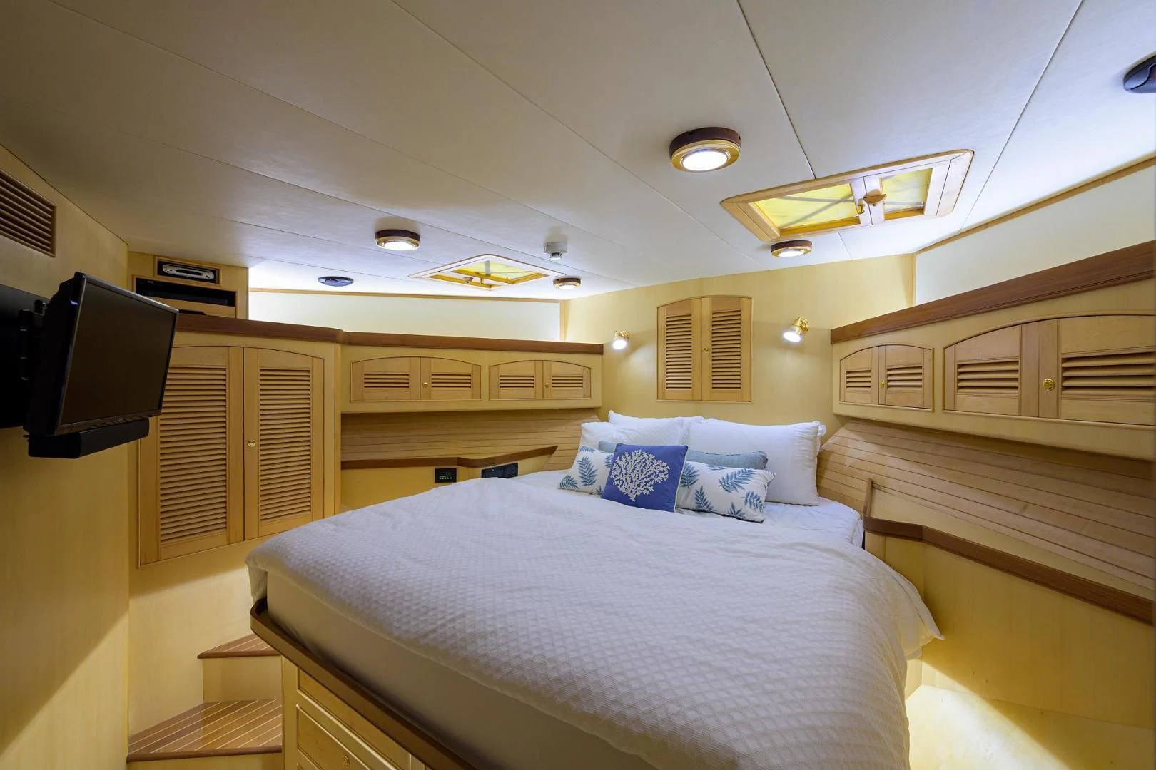 a room with a bed and tv aboard BELLA Yacht for Sale