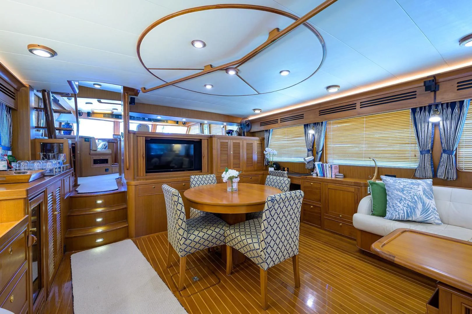 a living room with a table and chairs aboard BELLA Yacht for Sale