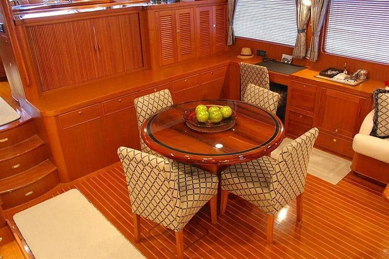 a table with chairs around it aboard BELLA Yacht for Sale
