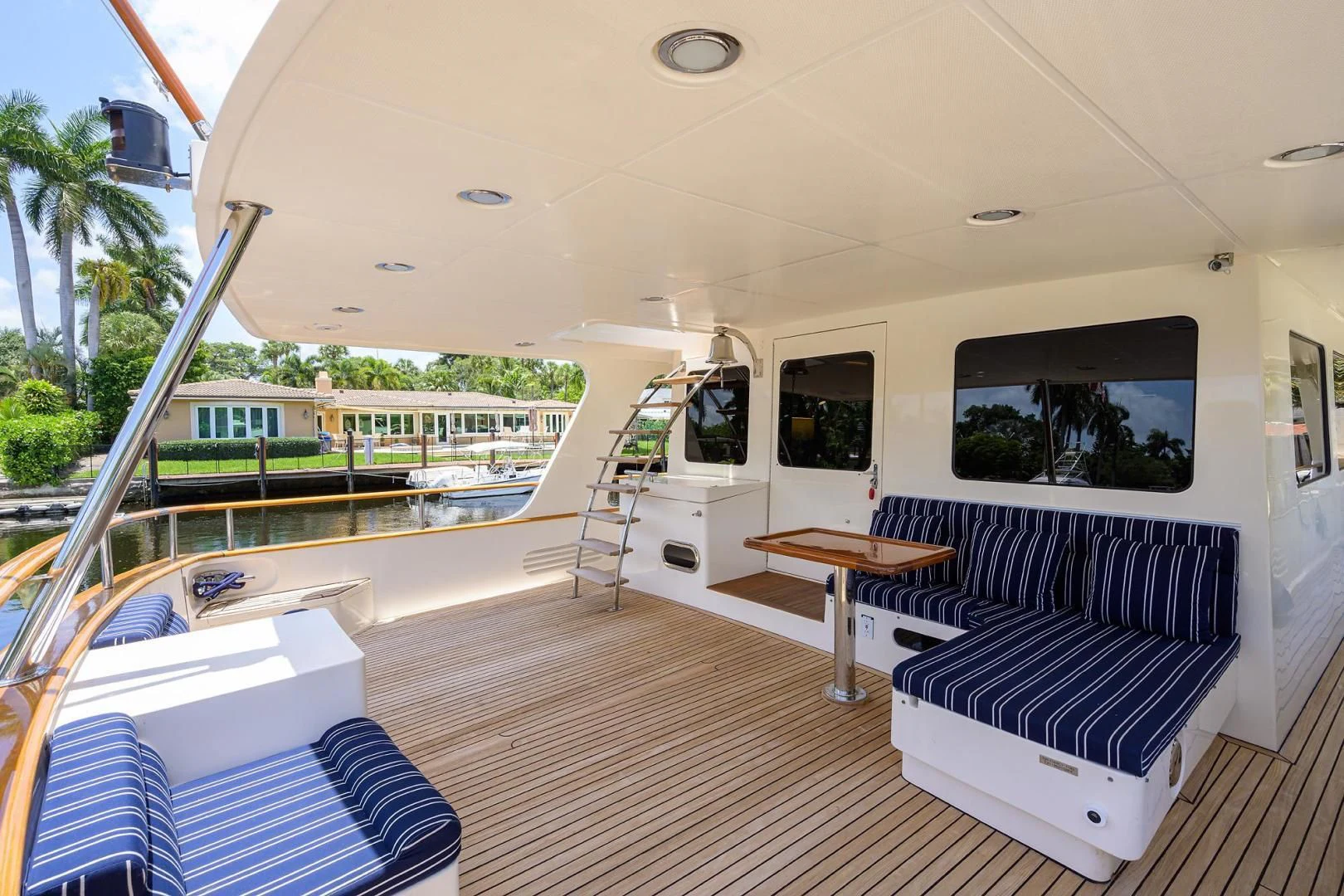 a large balcony with a table and chairs aboard BELLA Yacht for Sale