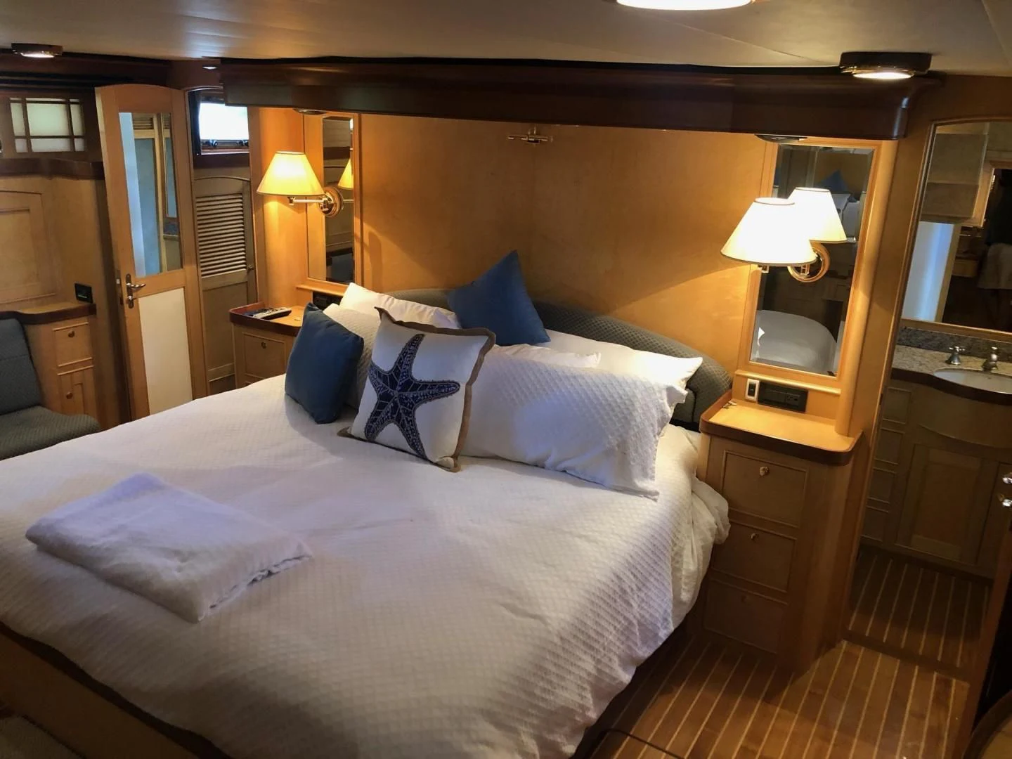 a bed with white sheets and pillows aboard BELLA Yacht for Sale