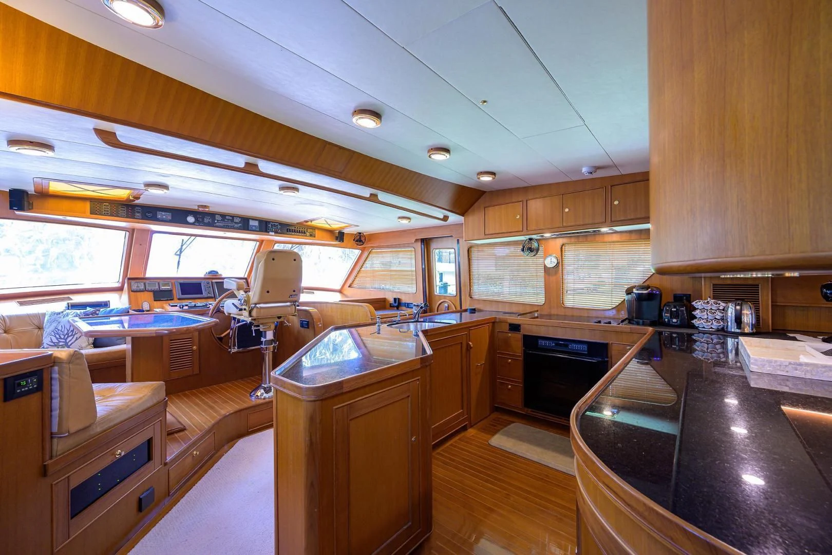 a kitchen with wooden cabinets aboard BELLA Yacht for Sale