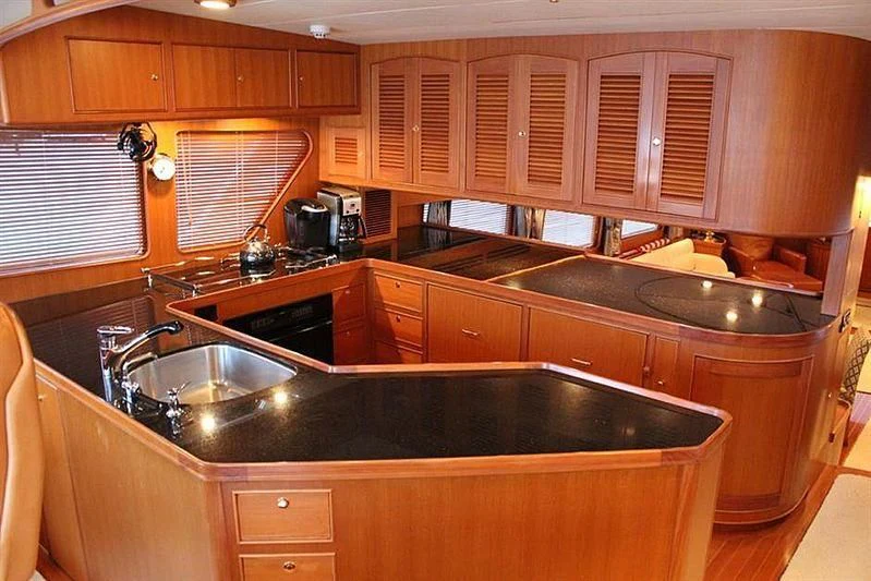 a kitchen with wooden cabinets aboard BELLA Yacht for Sale