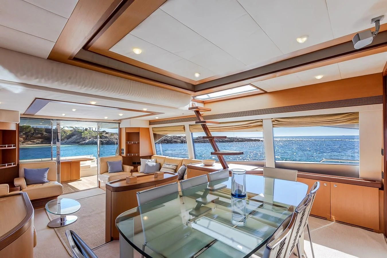 a room with a table chairs and a pool aboard BIJOU Yacht for Sale