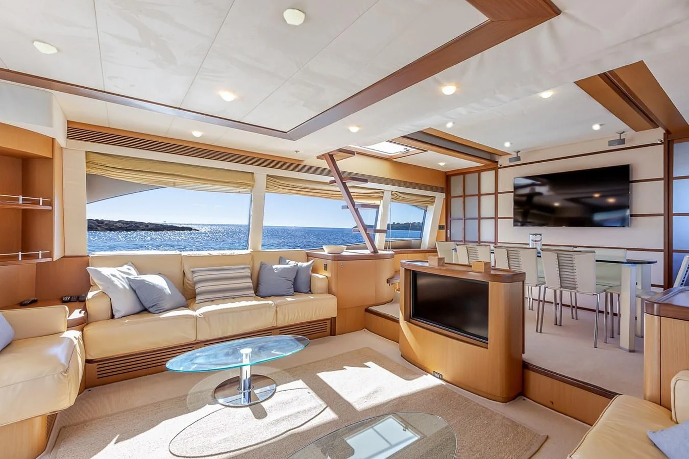 a living room with a large flat screen tv and a fireplace aboard BIJOU Yacht for Sale