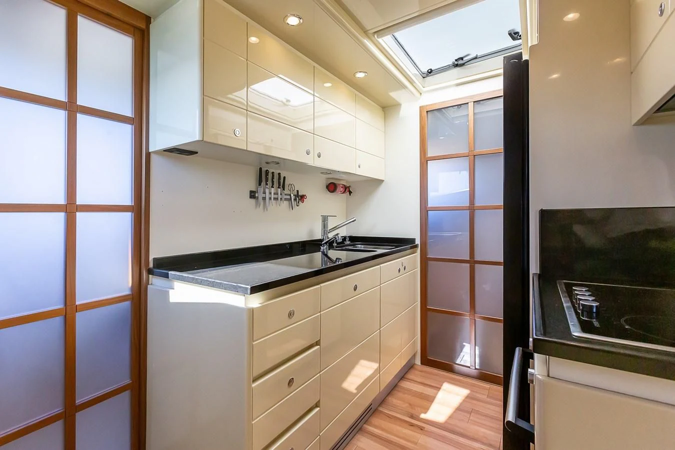 a kitchen with white cabinets aboard BIJOU Yacht for Sale