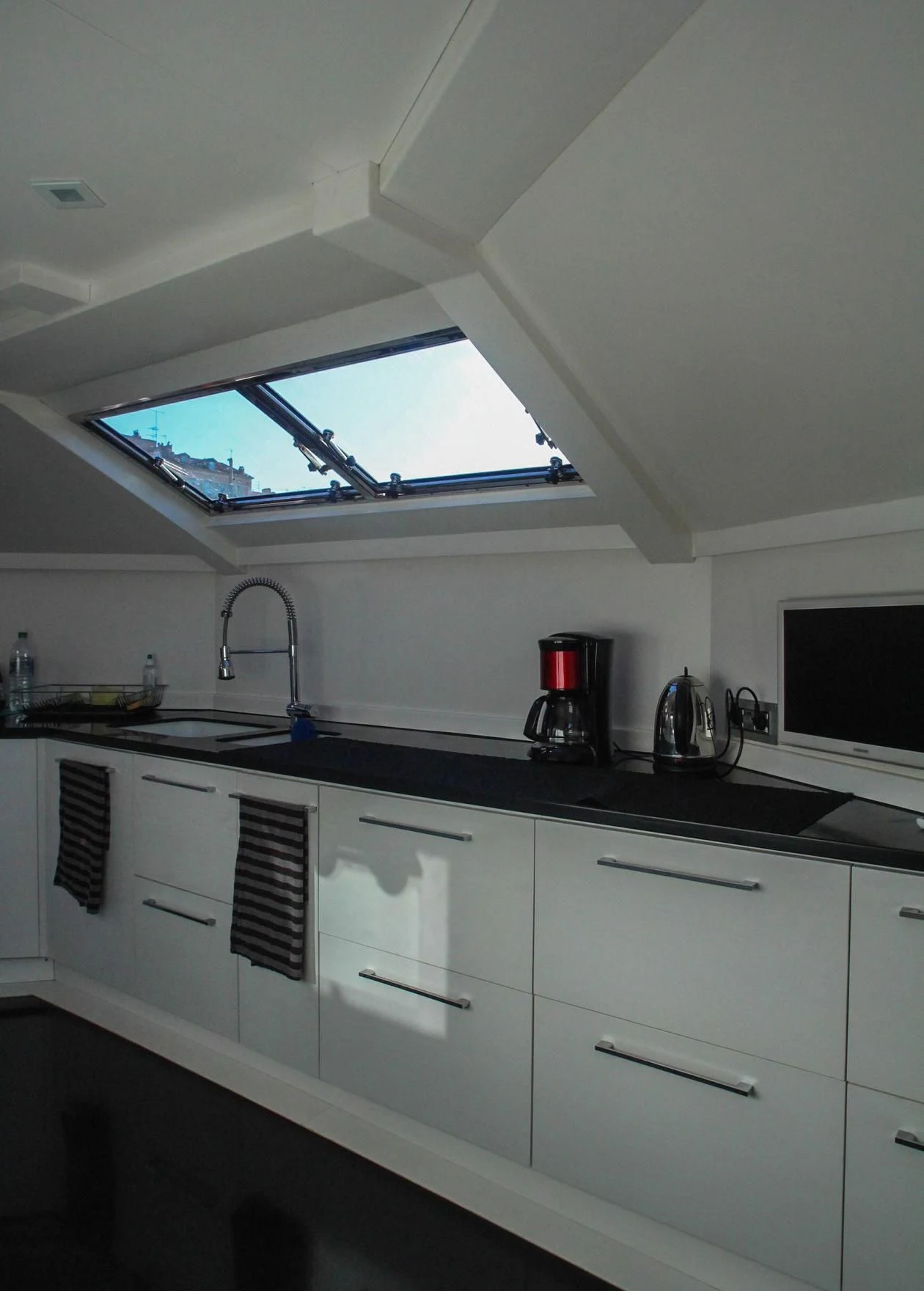 a kitchen with white cabinets aboard CIRCUS Yacht for Sale