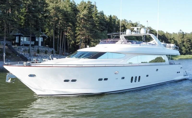 a white boat with a white stripe aboard JOYS Yacht for Sale