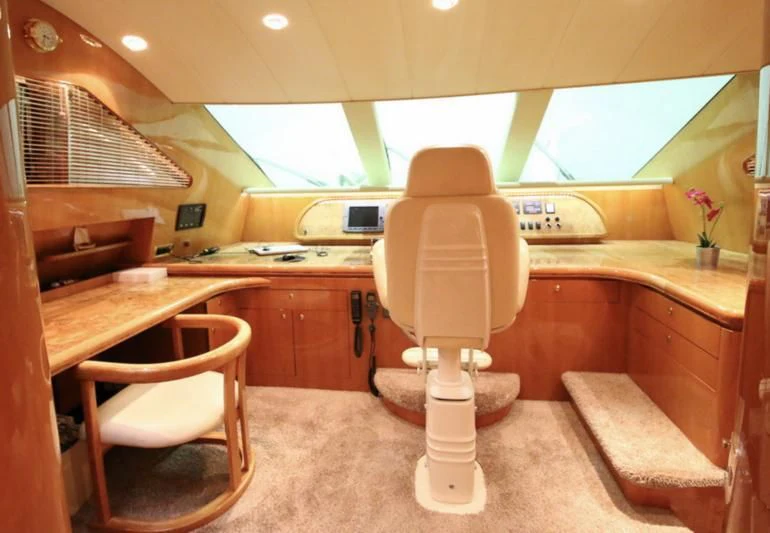 a room with a table and chairs aboard JOYS Yacht for Sale