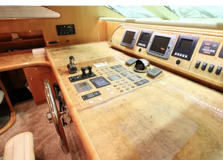 a table with a computer and a fan aboard JOYS Yacht for Sale