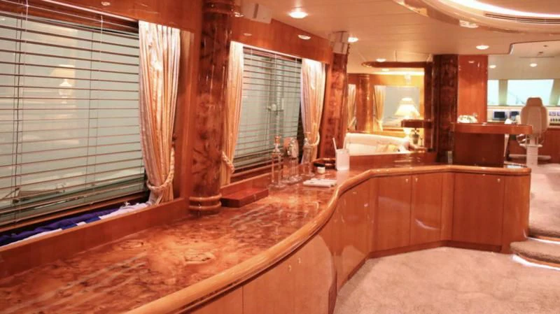 a room with wood floors and a large window aboard JOYS Yacht for Sale