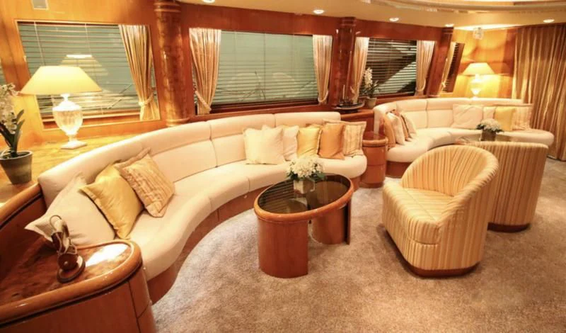 a living room with a couch and a table aboard JOYS Yacht for Sale