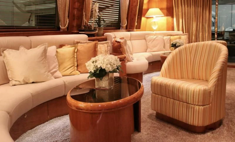 a living room with a couch and a coffee table aboard JOYS Yacht for Sale
