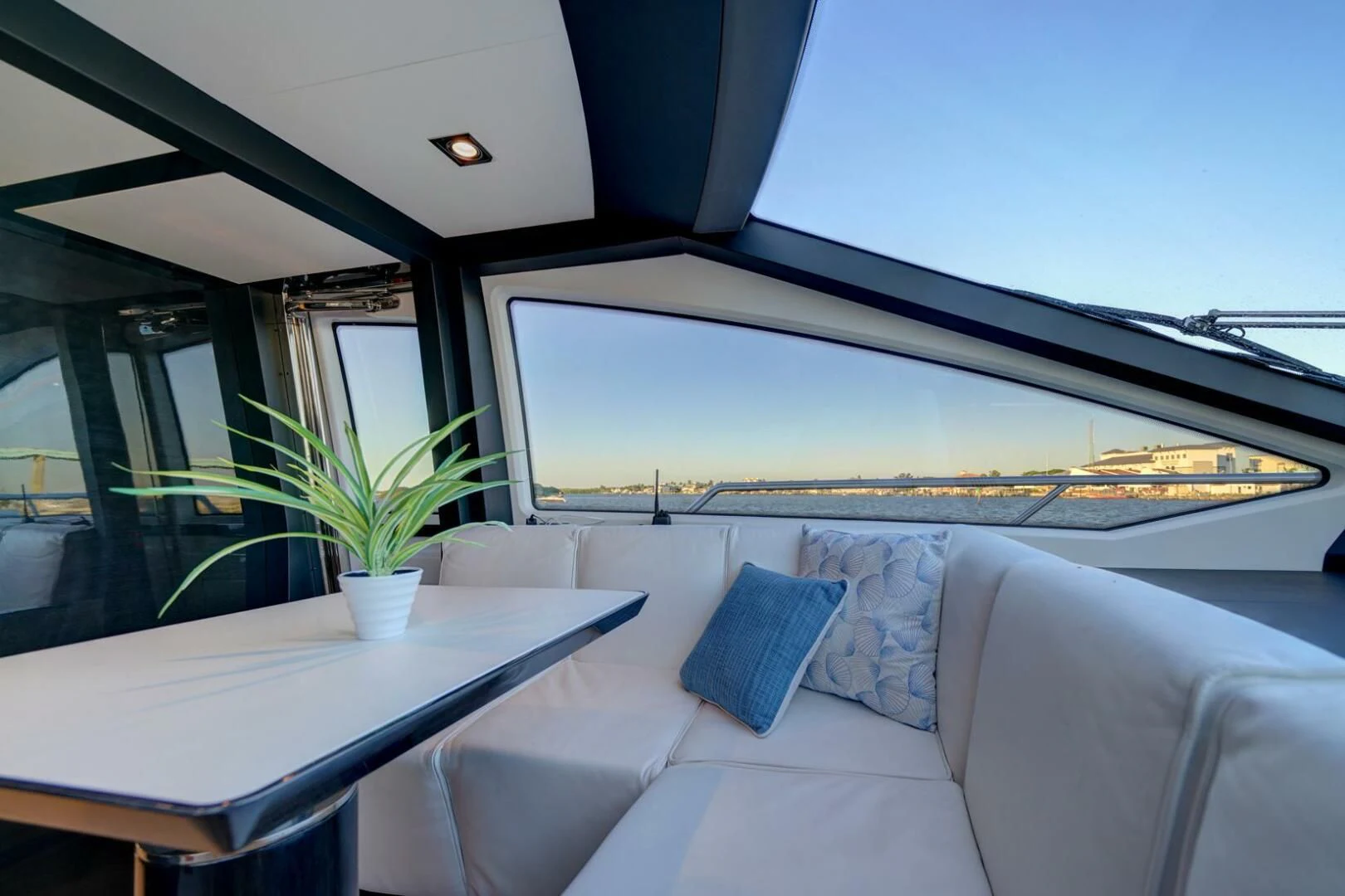 a room with a couch and a table with a plant on it aboard 80 AZIMUT Yacht for Sale