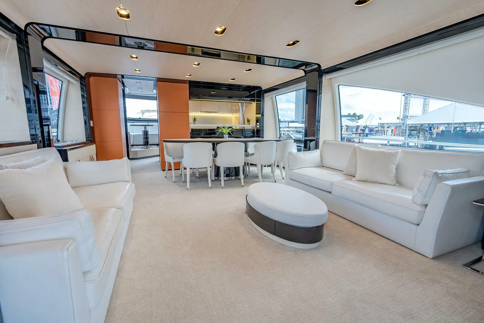 a living room with a large table and chairs aboard 80 AZIMUT Yacht for Sale