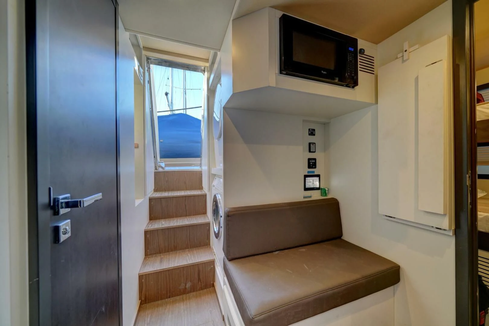 a room with a couch and a tv on the wall aboard 80 AZIMUT Yacht for Sale