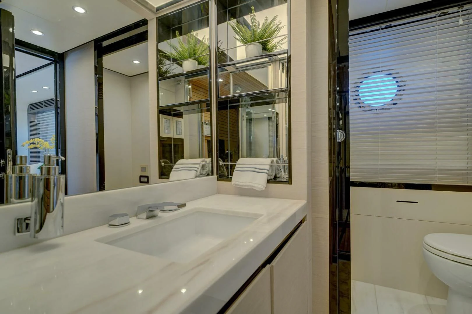 a bathroom with a large mirror aboard 80 AZIMUT Yacht for Sale