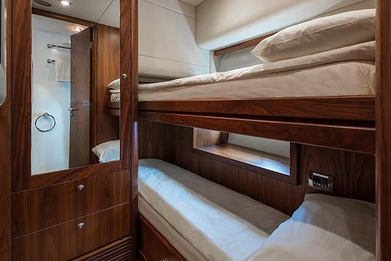 a room with a bed and a mirror aboard INFINITO Yacht for Sale