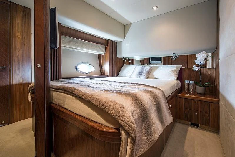a bed with a wooden headboard aboard INFINITO Yacht for Sale
