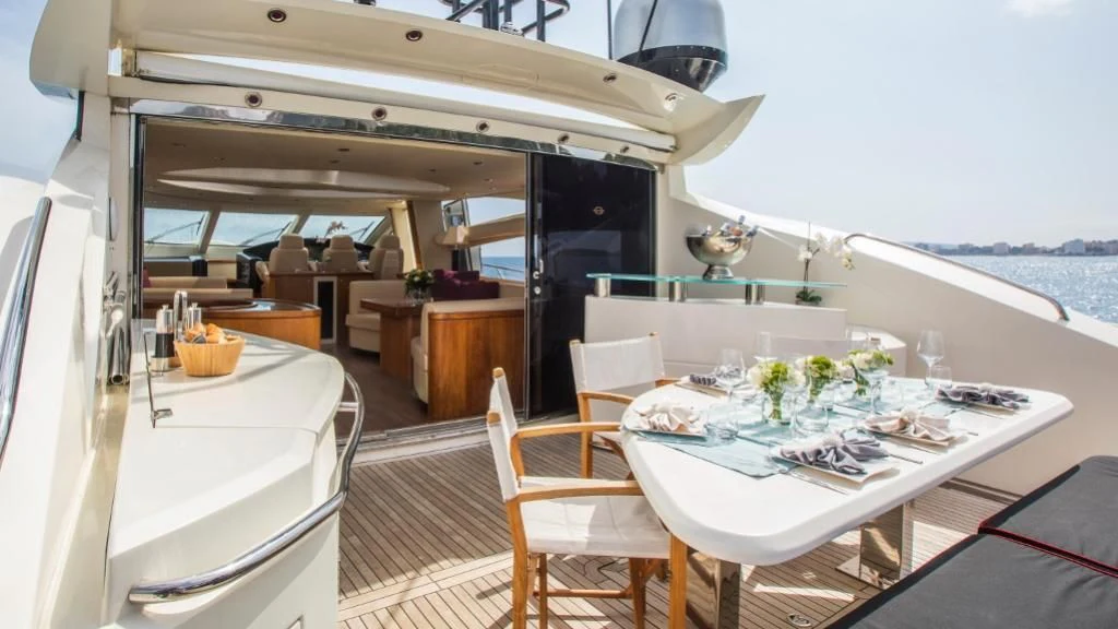a room with a table and chairs aboard INFINITO Yacht for Sale