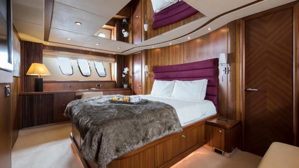 a bed in a room aboard INFINITO Yacht for Sale