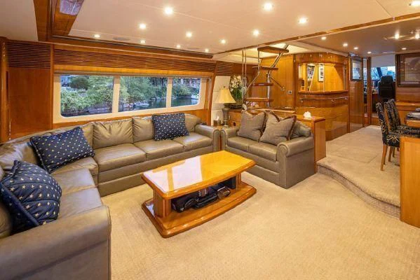 a living room with a couch and a coffee table aboard APOLLO Yacht for Sale