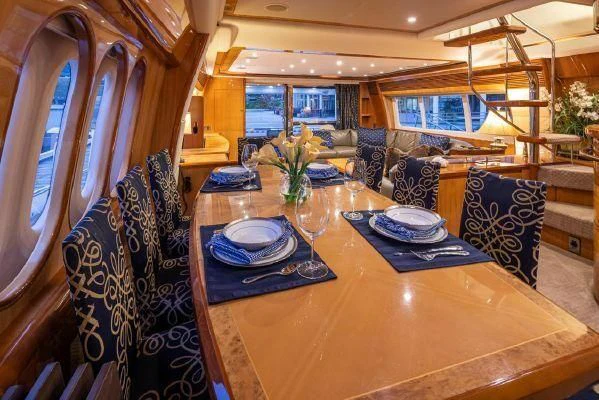 a dining table with plates and chairs aboard APOLLO Yacht for Sale