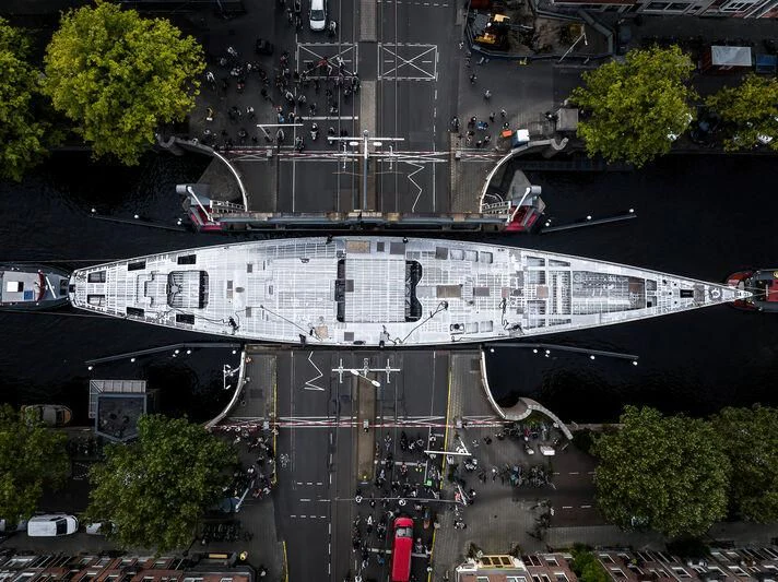 a large building with a lot of windows and a few people standing on the roof aboard PROJECT ZERO Yacht for Sale