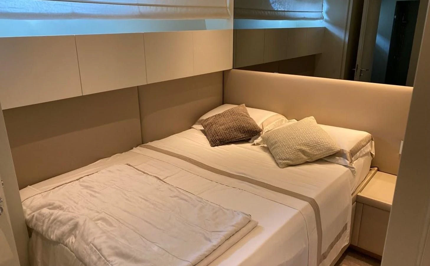 a bed with pillows aboard ACCI Yacht for Sale